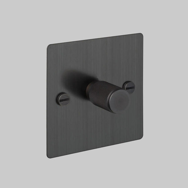 Single dimmer switch in black with a textured knob and visible screws