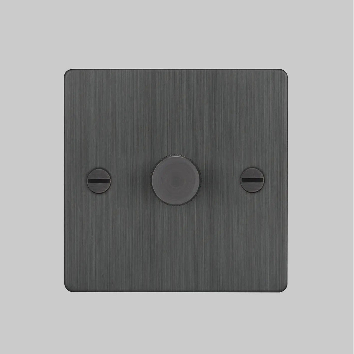 Brushed black metal dimmer switch with a single round knob and two flathead screws