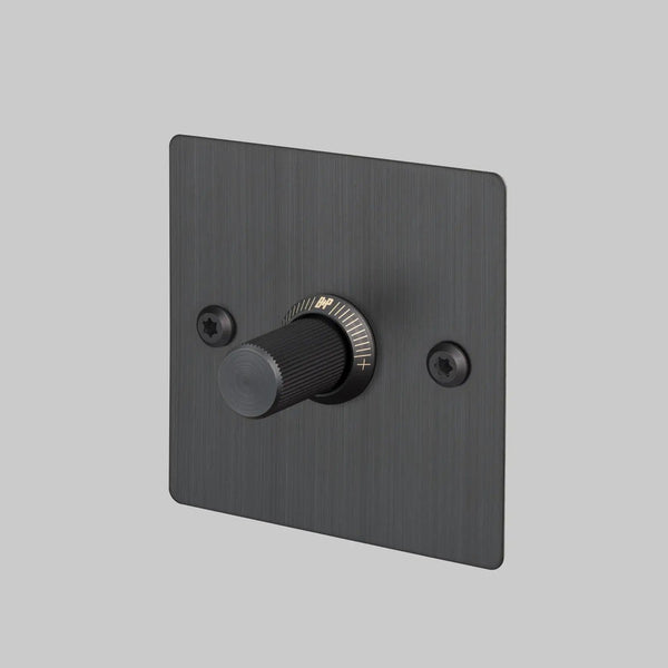 Black dimmer switch with a textured knob and a brushed metal faceplate