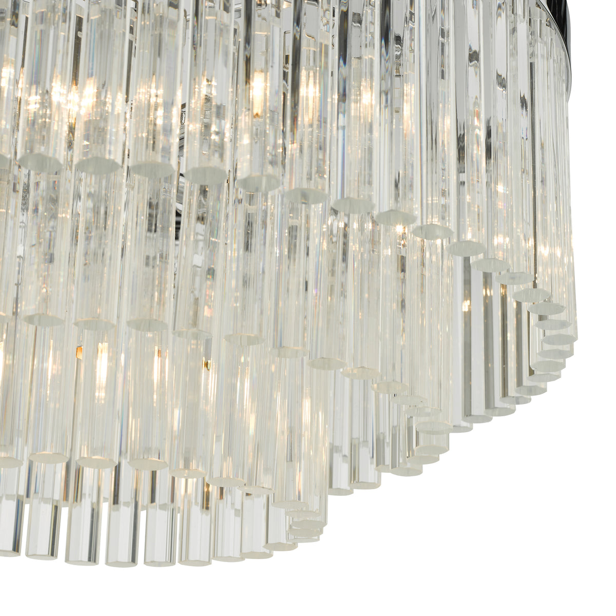 Close up of a modern chandelier with multiple clear glass rods arranged in a tiered pattern, illuminated from within