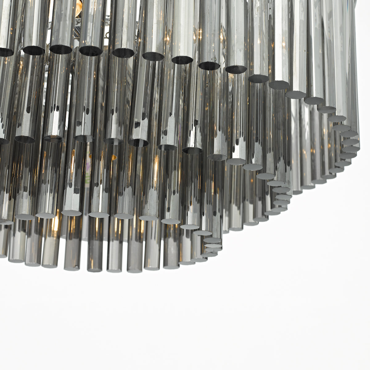 Close-up of a modern chandelier with multiple reflective, cylindrical glass rods.