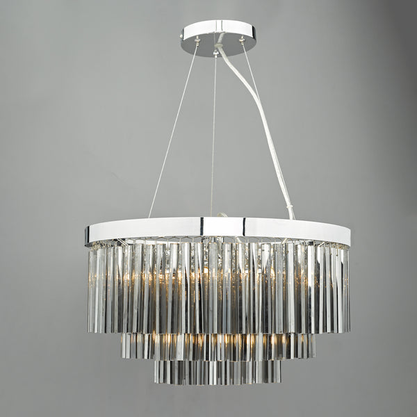 A three-tiered chandelier with clear glass rods and a chrome finish, illuminated against a gray background.