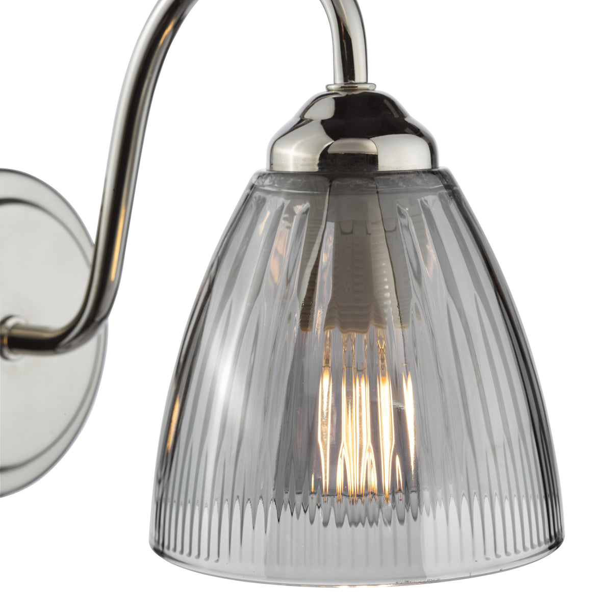 Polished nickel wall light with a fluted clear glass shade and exposed filament bulb