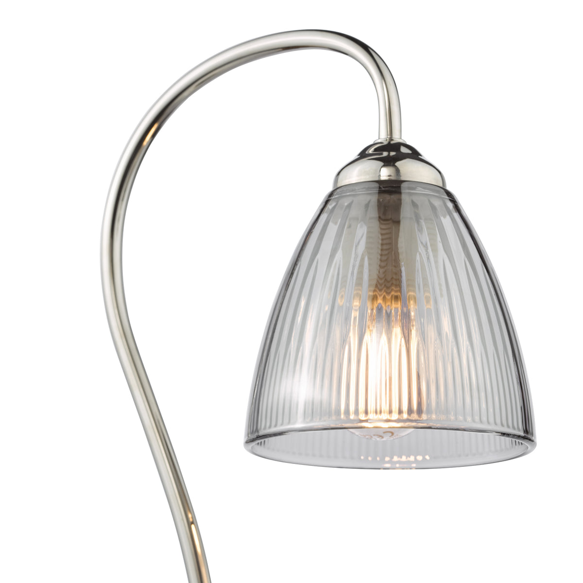 Curved metal lamp with a fluted glass shade and an illuminated bulb