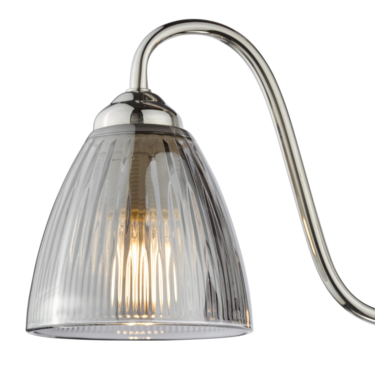 Close up of a polished nickel light fixture with a clear ribbed glass shade