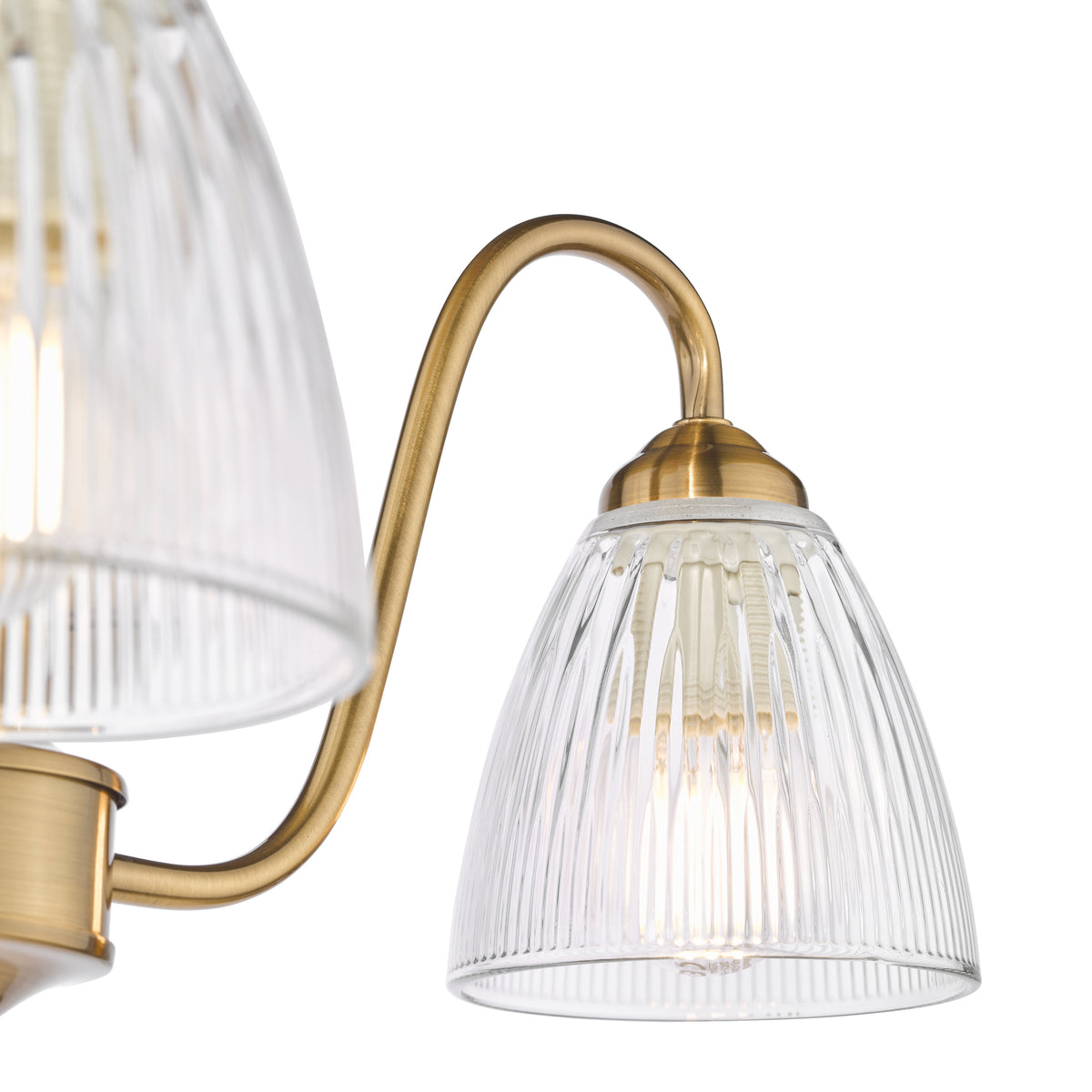 Close up of a brass light fixture with two ribbed glass shades