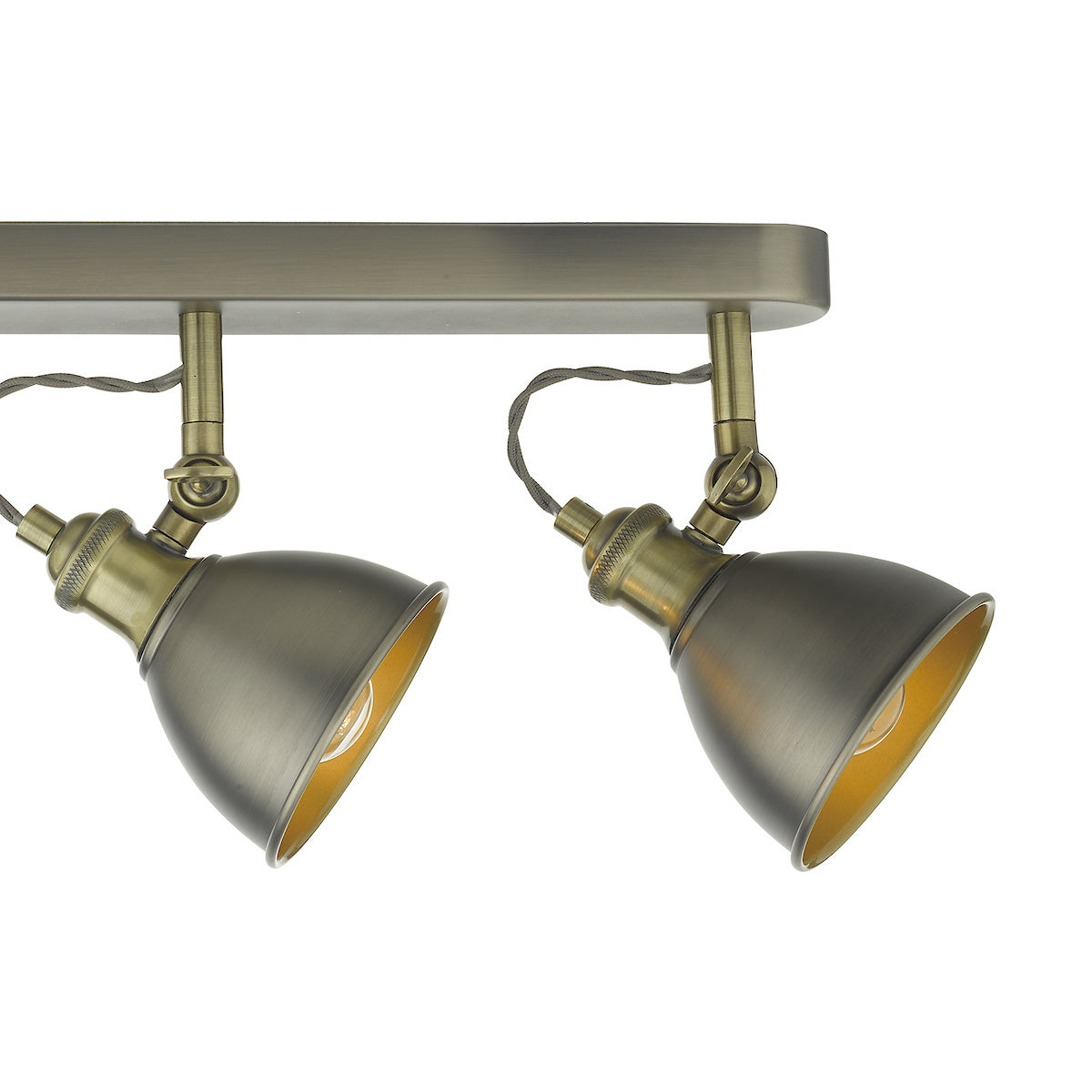 Two antique brass adjustable spotlights on a track