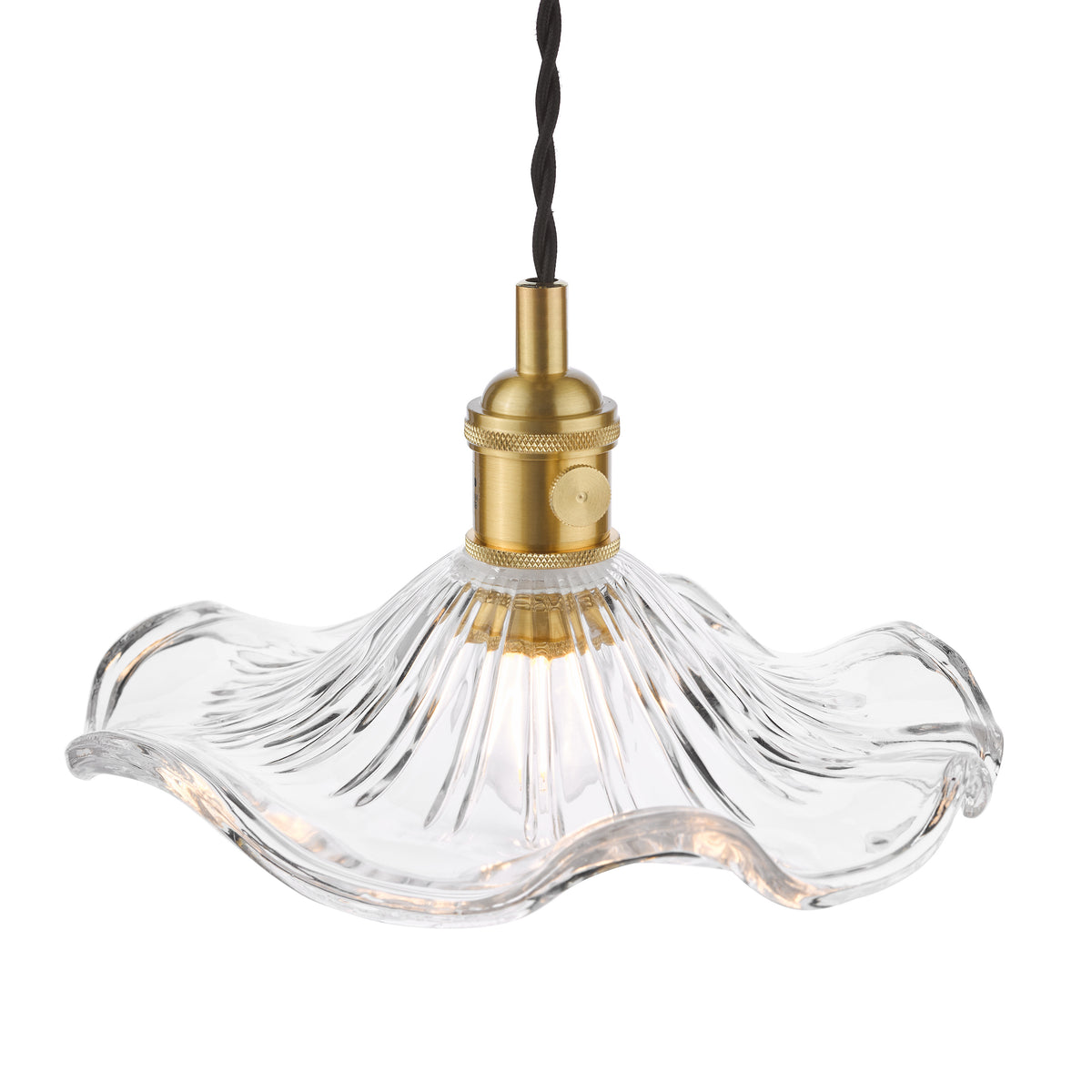 Clear glass pendant light with a ruffled edge and brass fitting, illuminated against a white background.