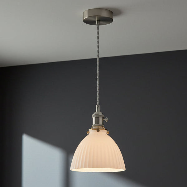 White fluted glass pendant light with brushed nickel hardware and a twisted grey fabric cord. 