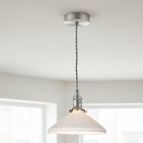 A white fluted glass pendant light with a brushed nickel fixture and a grey braided cord.