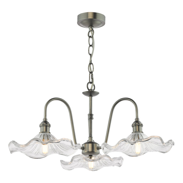 Antique brass chandelier with three wavy glass shades and exposed filament bulbs.
