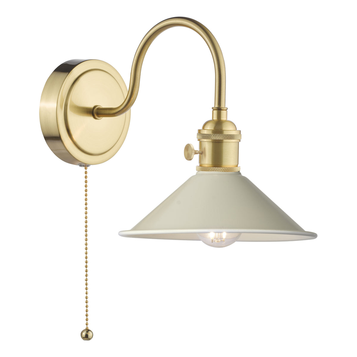 A brass wall sconce with a curved arm, a cream-colored conical shade, and a pull chain switch.