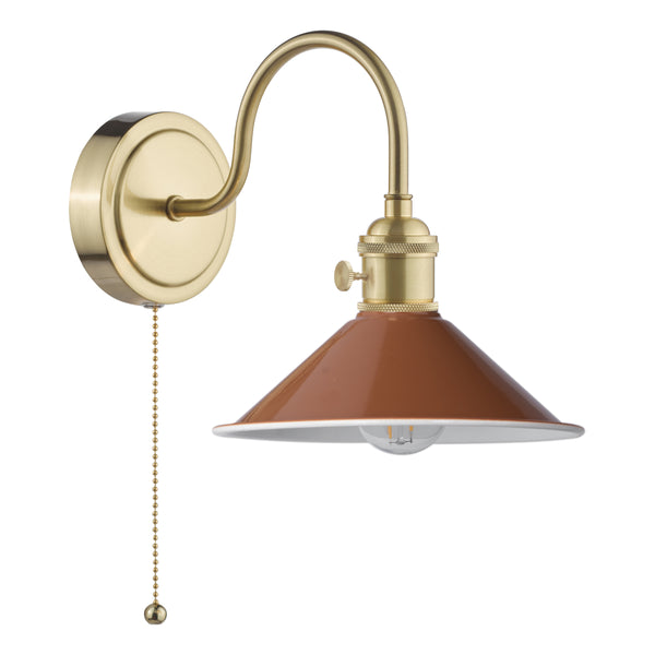 Brass wall sconce with a curved arm and a rust-colored, cone-shaped shade. It has a pull chain switch.
