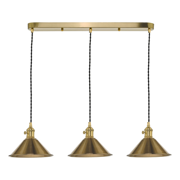 Three brass pendant lights with black braided cords hang from a rectangular brass bar.