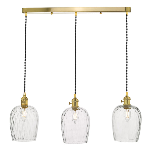 Three clear glass pendant lights with textured shades and brass fittings, hanging from a brass bar.
