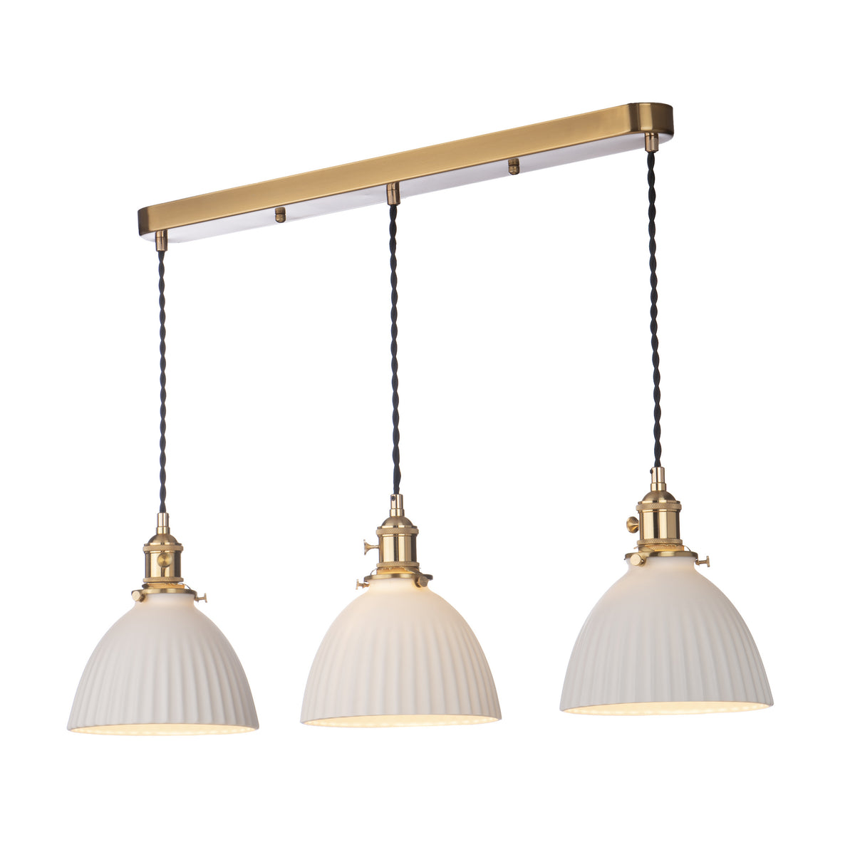 Three white fluted pendant lights with brass accents hang from a gold bar.