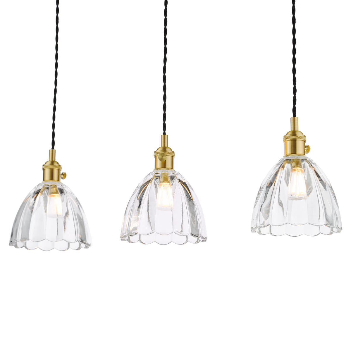 Three clear glass pendant lights with brass fittings and black braided cords, illuminated against a white background.