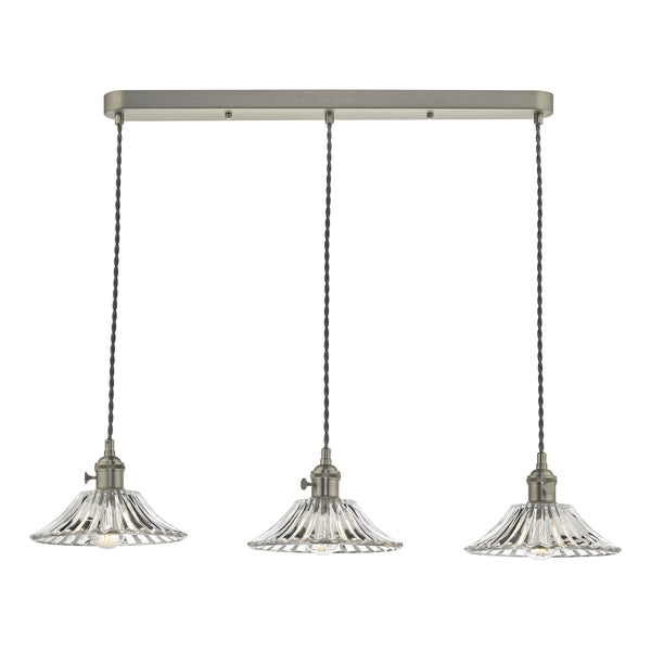 Three pendant lights with fluted glass shades and a brushed nickel bar, hanging from twisted black cords.