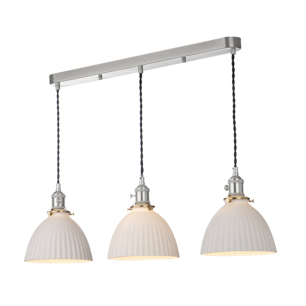 Three white ribbed dome pendant lights hang from a brushed metal bar, with black braided cords.