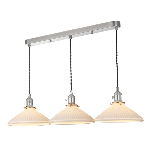 Three white pleated pendant lights hang from a brushed nickel bar, with twisted black cords and brass accents. 