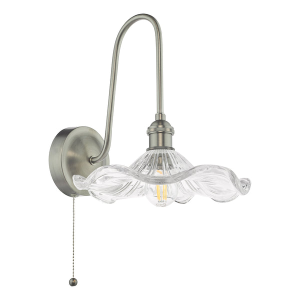 Brushed nickel wall sconce with a clear, ruffled glass shade and exposed bulb. A pull chain hangs below.
