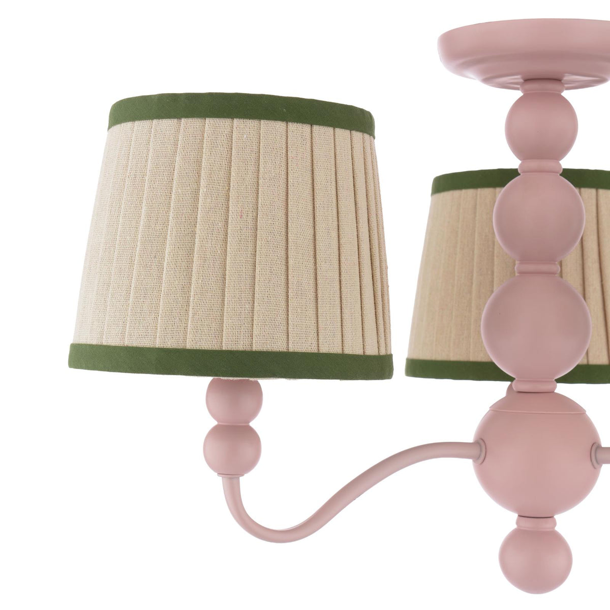 Pink metal chandelier with pleated beige fabric shades and green trim