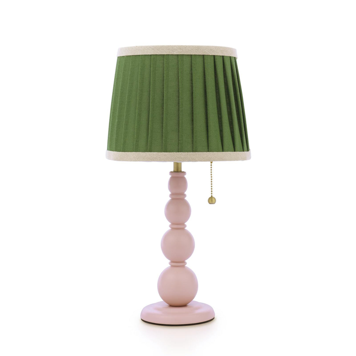 Table lamp with a pleated green fabric shade and a pink stacked sphere base