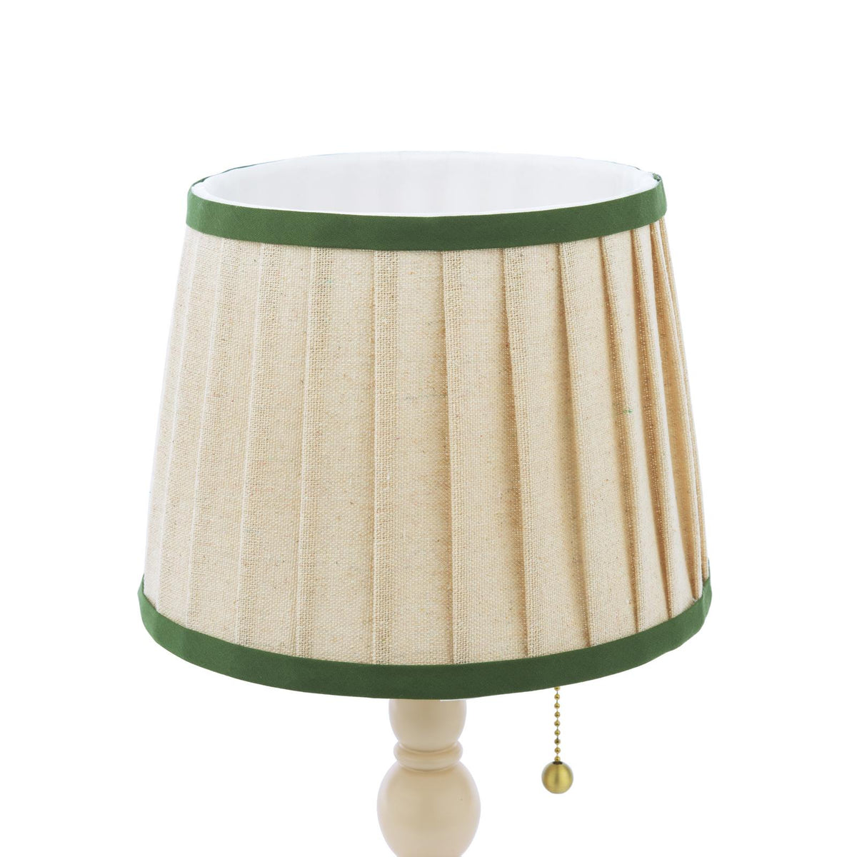 Beige pleated fabric lamp shade with green trim