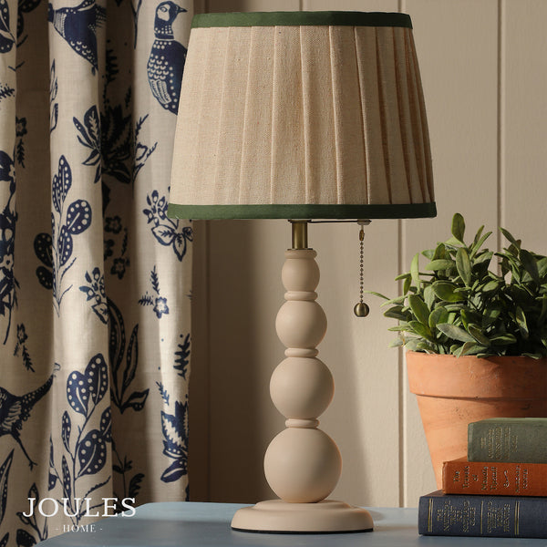 Joules Harewood table lamp in matt cream with a pleated linen shade and green trim