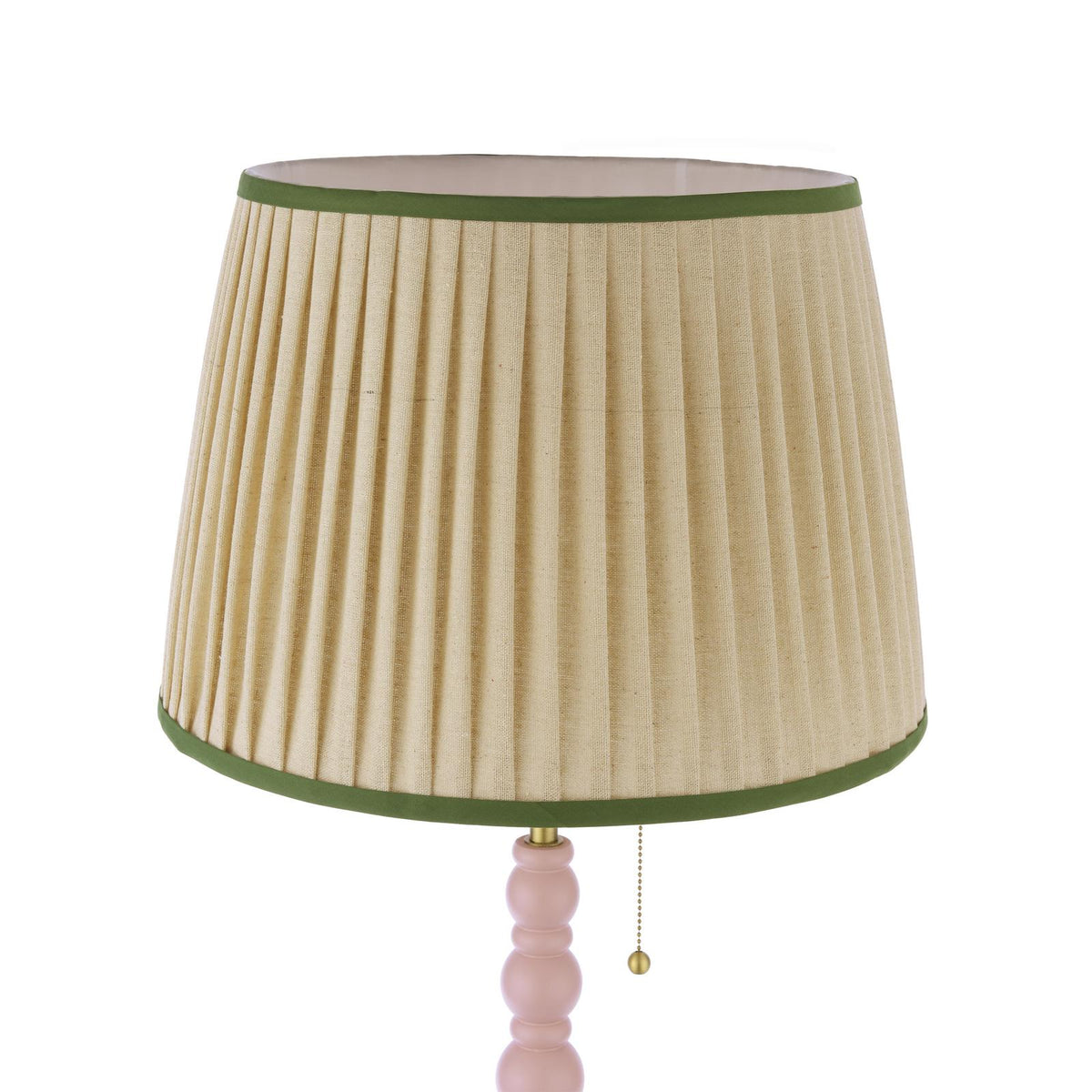 Pleated beige lampshade with green trim on a pink ball base