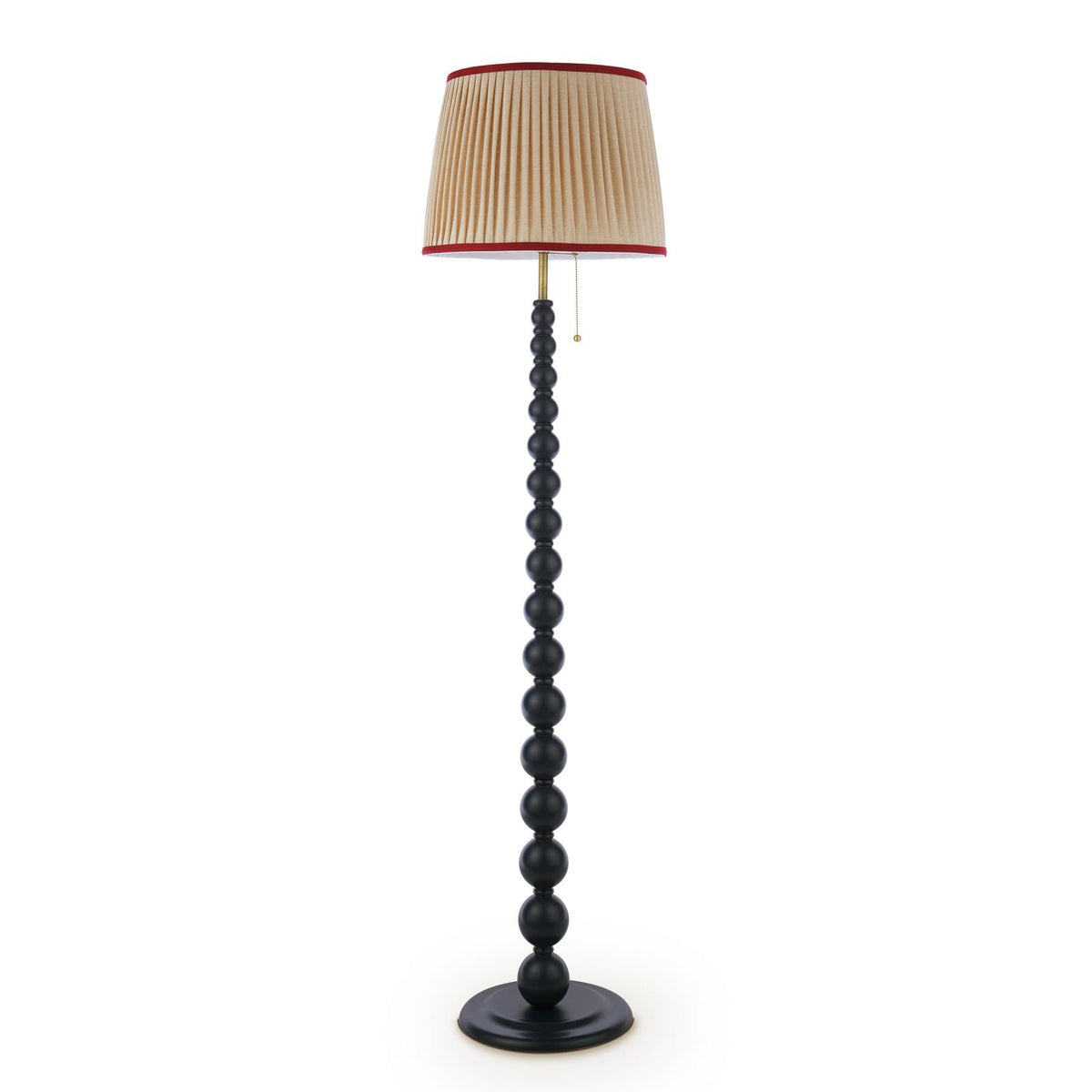 Black floor lamp with a stacked ball stand and a pleated beige lampshade with red trim