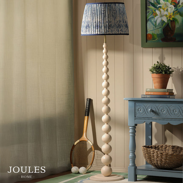 Joules Home floor lamp with a cream beaded stand and a blue patterned pleated shade