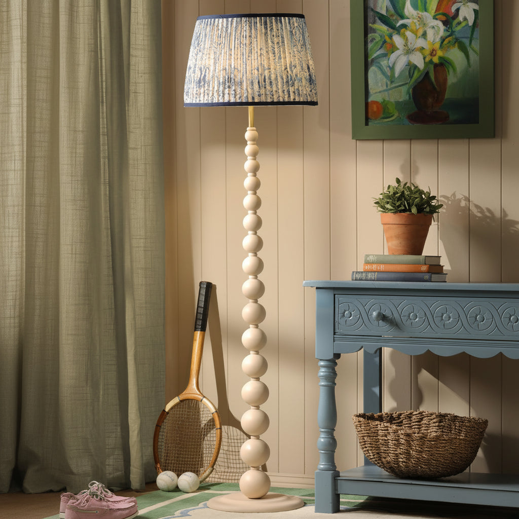 Floor lamp with a stacked sphere base and blue patterned fabric shade