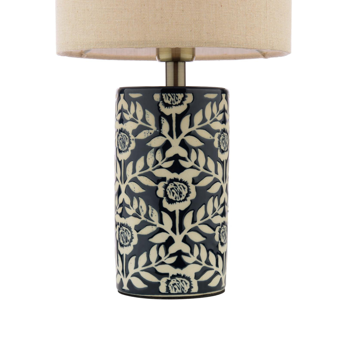 Cylindrical ceramic table lamp with navy and cream floral pattern and beige fabric drum shade