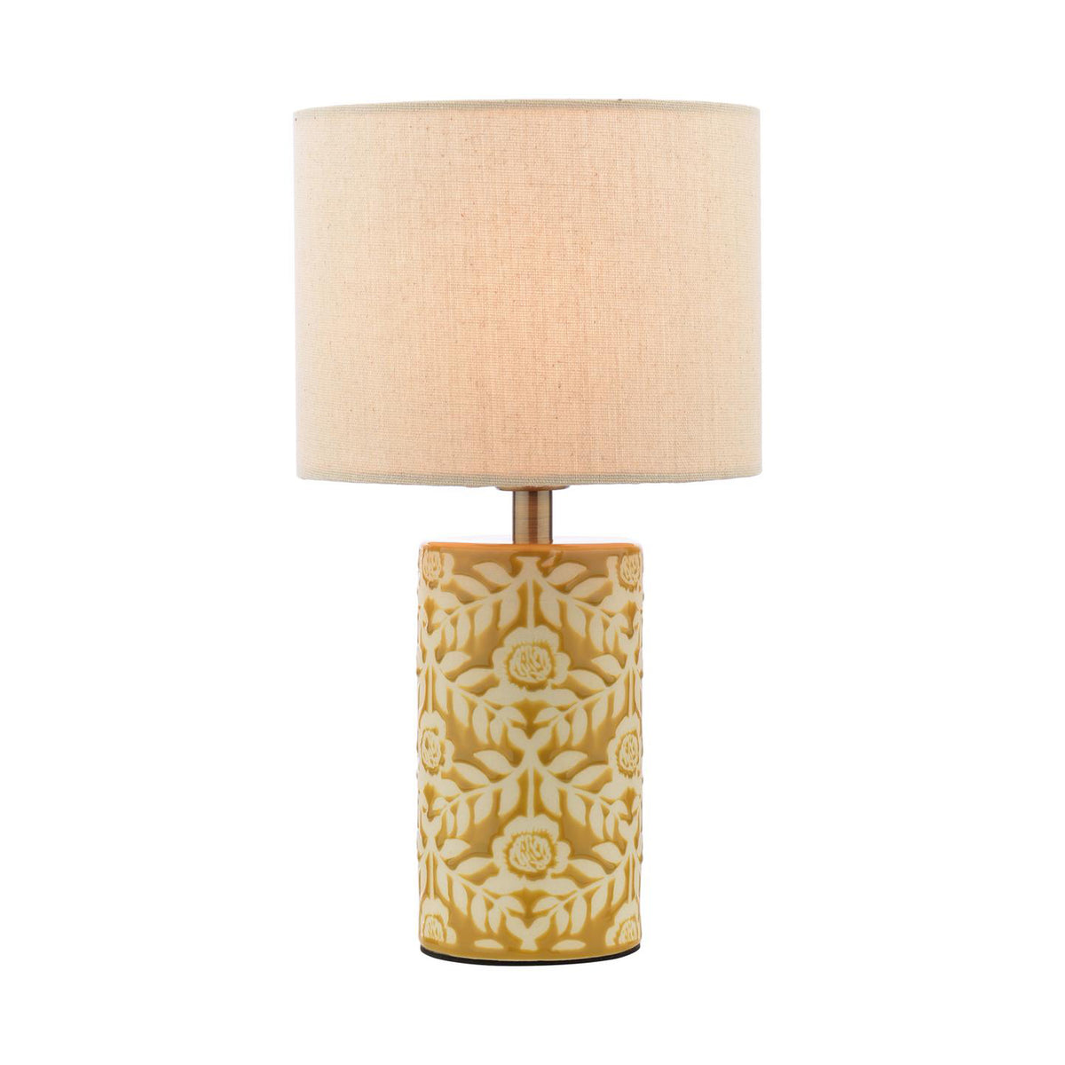 Table lamp with a cylindrical mustard yellow ceramic base featuring a white floral pattern and a beige fabric drum shade