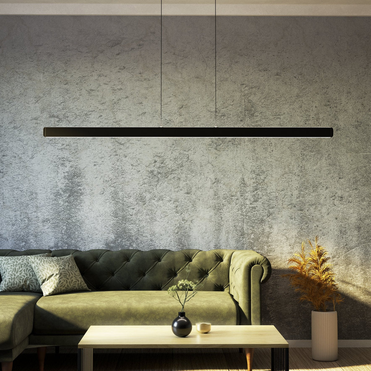 Living room with green sofa, light wood coffee table, and a long black linear pendant light