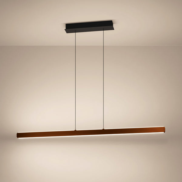 Linear pendant light in a copper finish with a black ceiling mount