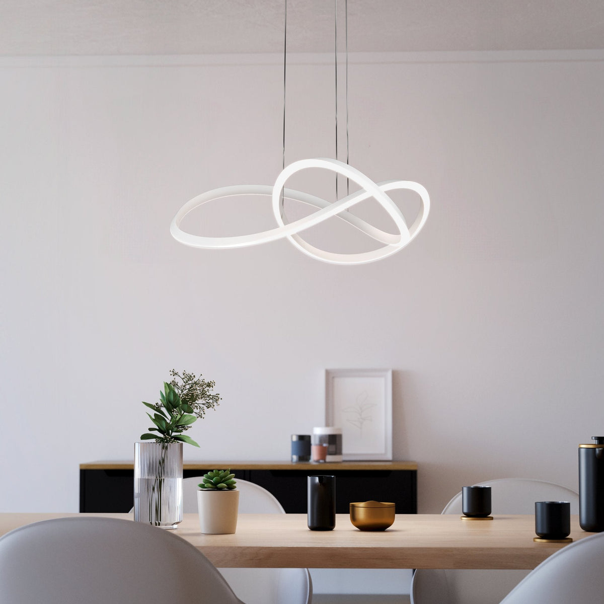 Modern dining room with a white, illuminated, abstract pendant light above a wooden table
