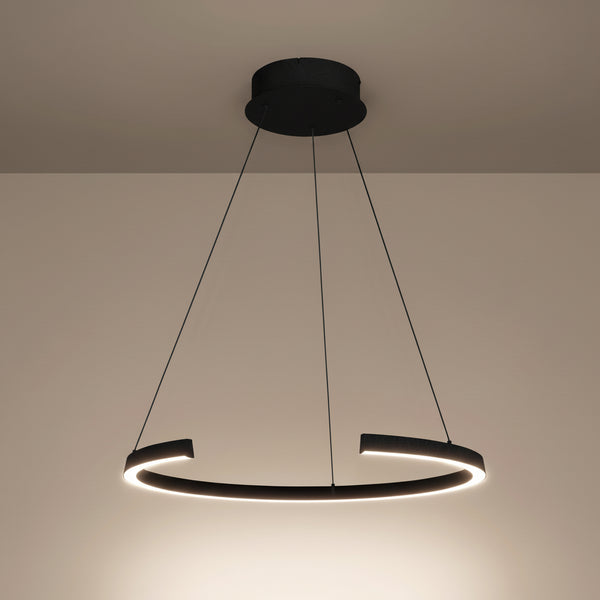 Black circular pendant light with an illuminated inner edge hanging from a ceiling