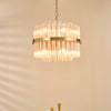 Imani Twelve Light Pendant in Natural Brass with Champagne Ribbed Glass Rods