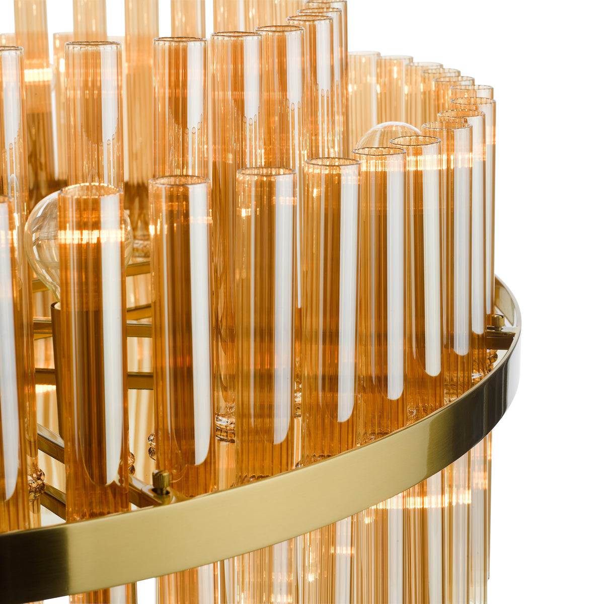 Close up of a gold chandelier with amber glass tubes and exposed light bulbs