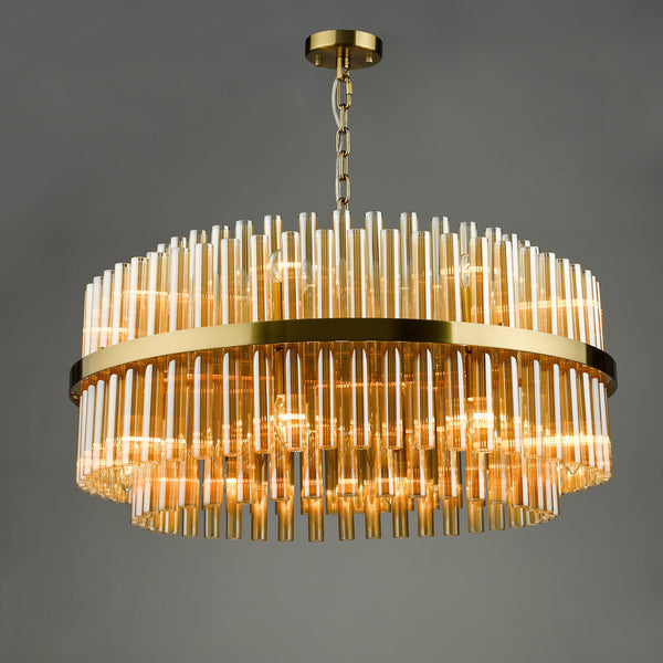 Round chandelier with amber glass rods and a gold metal frame