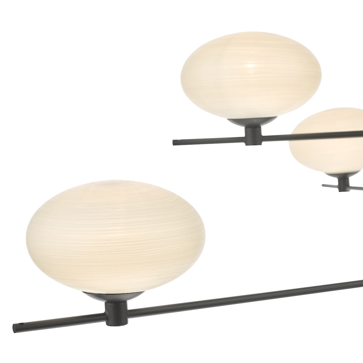 Close-up of a modern chandelier with three spherical, textured glass shades on black metal rods.