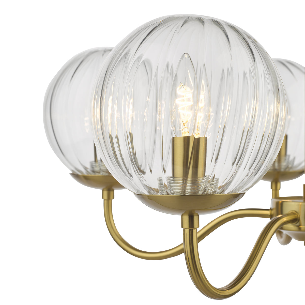 Close up of a brass chandelier with three clear, ribbed glass globes and exposed bulbs