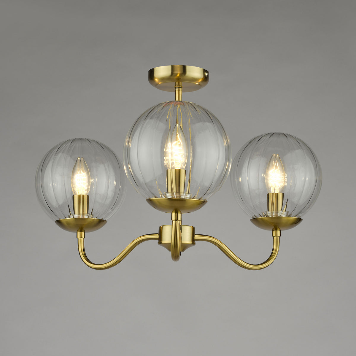 Three-light brass chandelier with ribbed glass globes