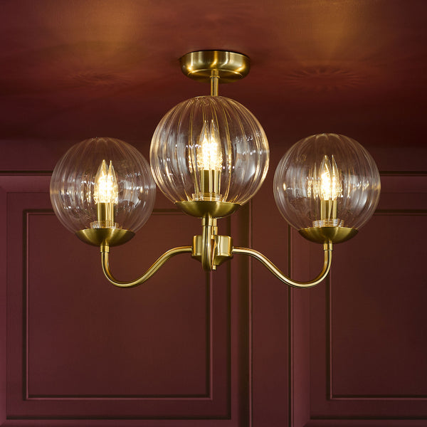 Three-light brass chandelier with ribbed glass globes