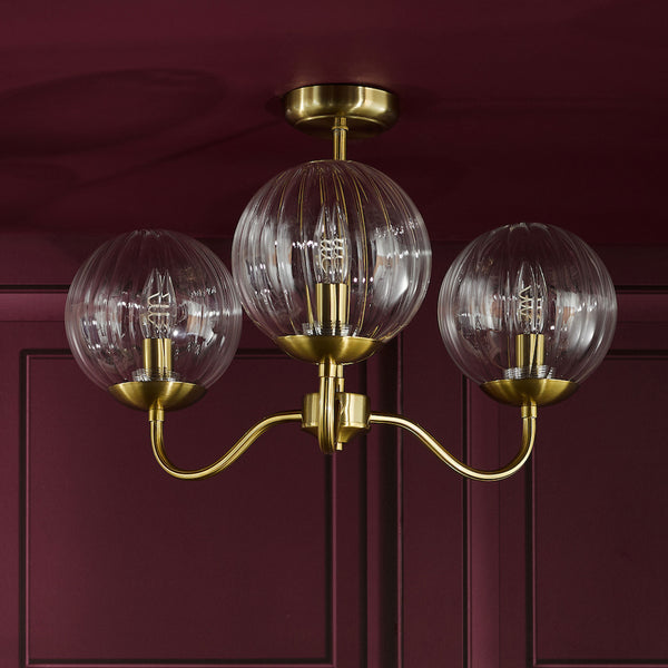 Three-light brass ceiling light with ribbed glass shades