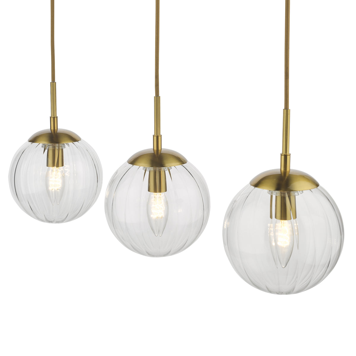 Three pendant lights with clear ribbed glass shades and brass hardware