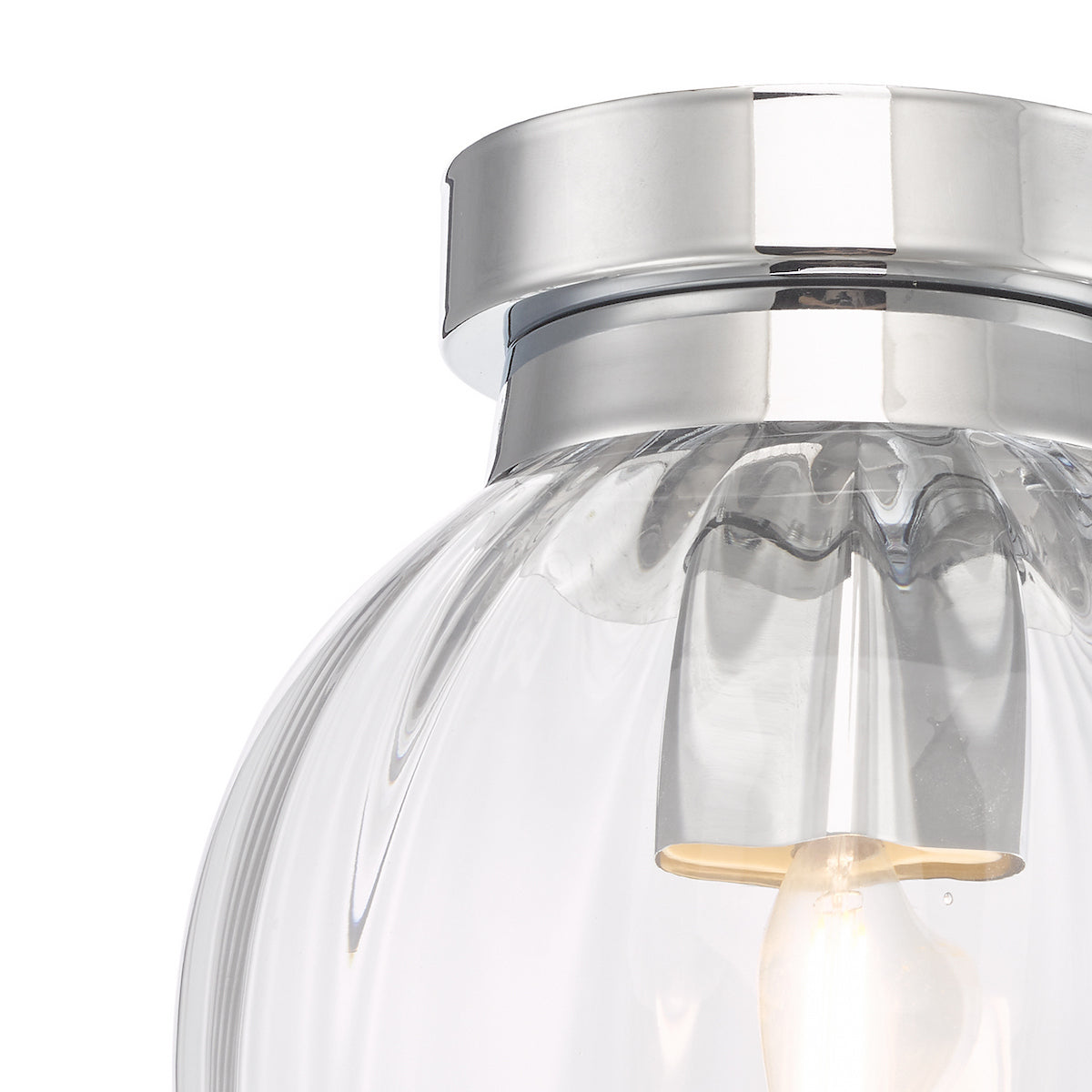 Close-up of a clear, ribbed glass light fixture with a chrome base and an illuminated bulb.
