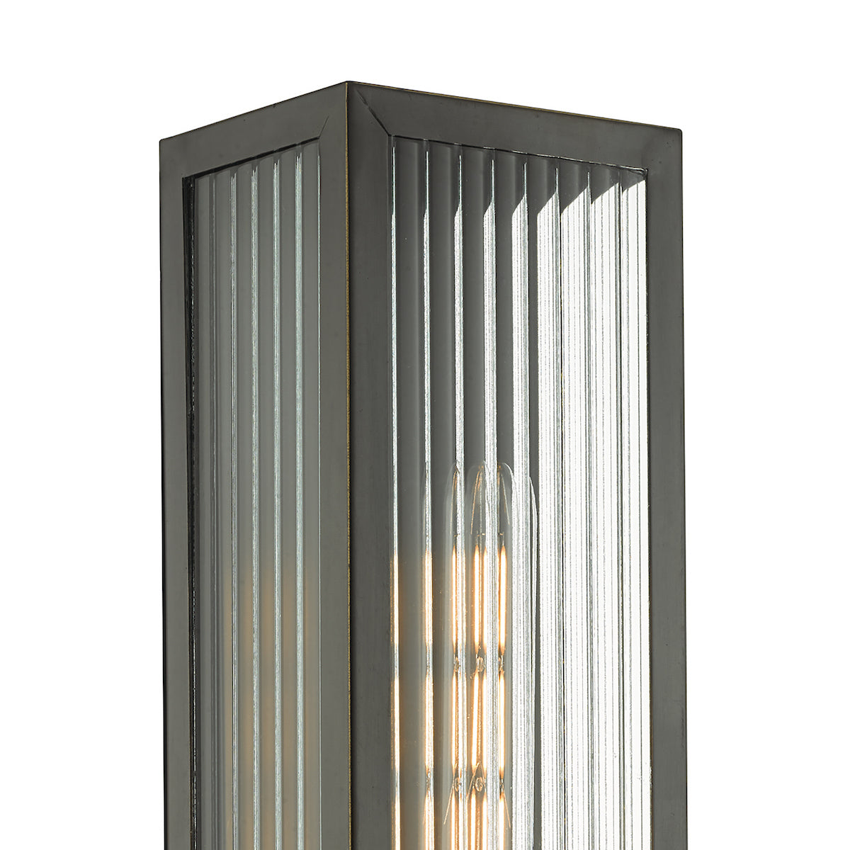 Close up of a rectangular wall light with a dark metal frame and fluted glass panels